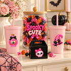 Pink Halloween UV DTF designs displayed on a Halloween candy station