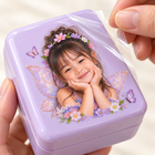 Applying a personalized fairy portrait UV DTF transfer to a lavender lunchbox