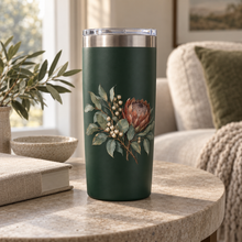 Botanical artwork applied to a forest green tumbler